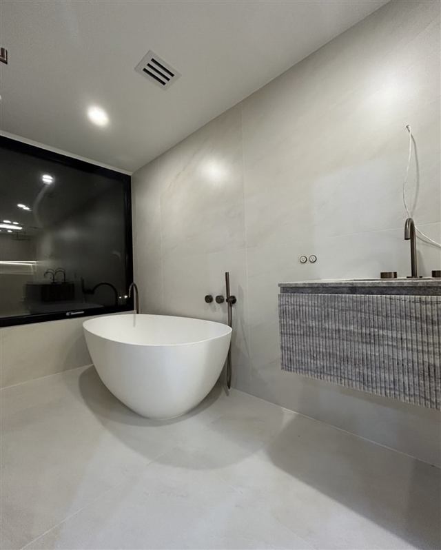 Freestanding soaking tub in a luxury bathroom remodel by Mavr Construction