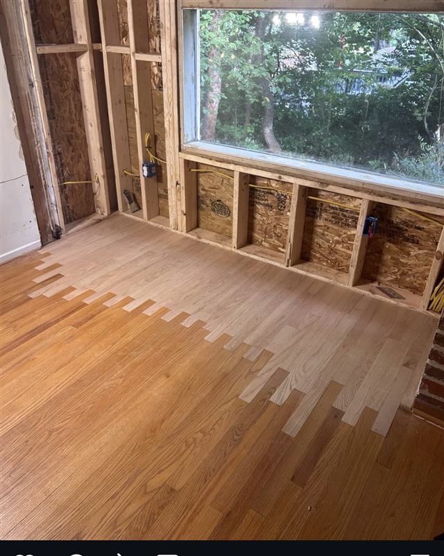 New hardwood flooring woven into existing floor during a remodel